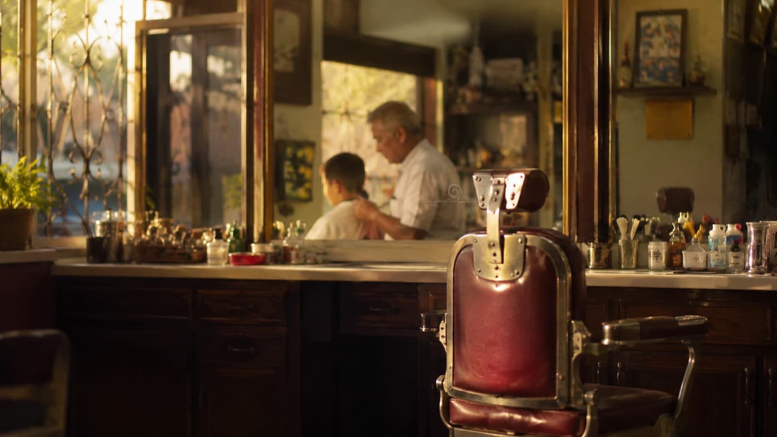 old barbershop chair and mirror in warm morning light
